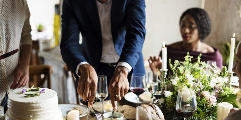 Hands Holding Knife and Fork Getting Food From Dish