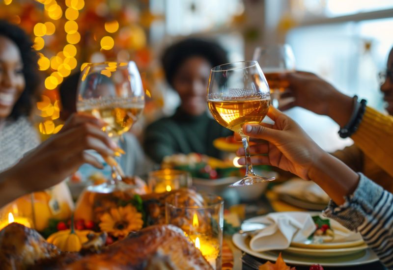 people-are-sitting-table-with-glasses-wine-plate-food-with-flowers-it